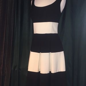 Sleeveless scoop neck Cocktail dress with soft pleated skirt.